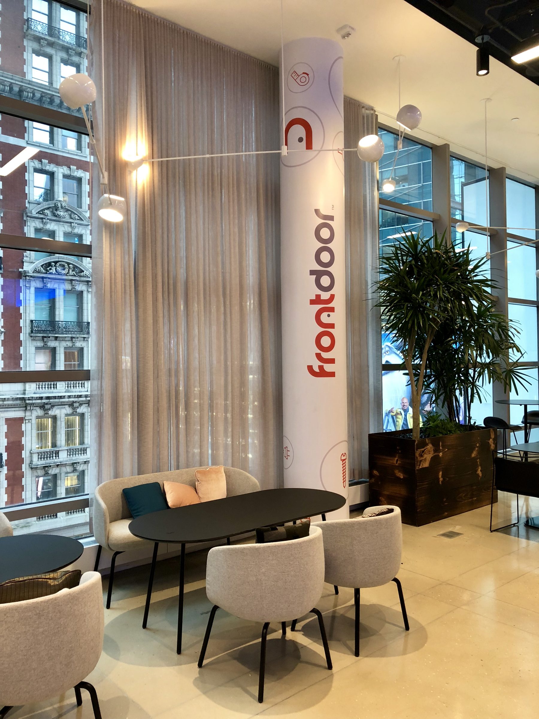 Frontdoor-branded column with home-service icons in the New York office