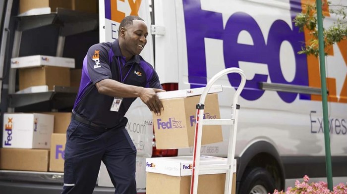 FedEx Solutions That Matter campaign: courier loading packages from a FedEx van